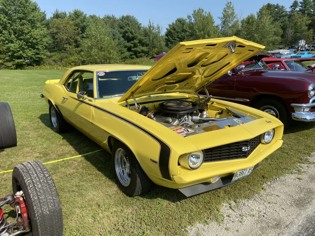 Yellow 1969 Chevrolet Camaro SS with its hood open at Freddie's Cruise-In 2022.