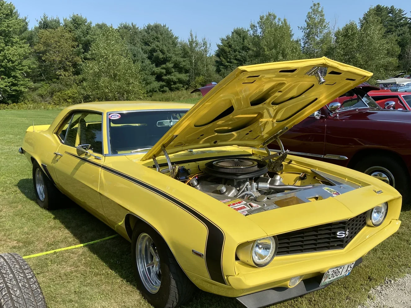 Yellow 1969 Chevrolet Camaro SS with its hood open at Freddie's Cruise-In 2022.