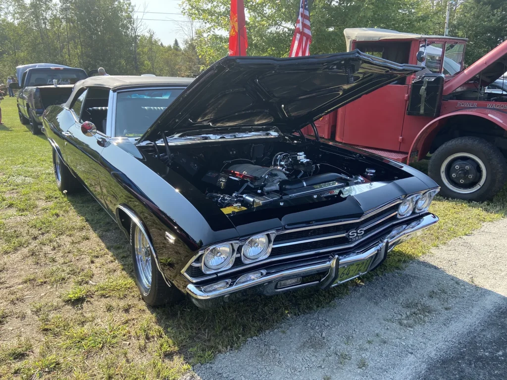 Black 1969 Chevrolet Chevelle SS 396 convertible with its hood open at Freddie's Cruise-In 2022.