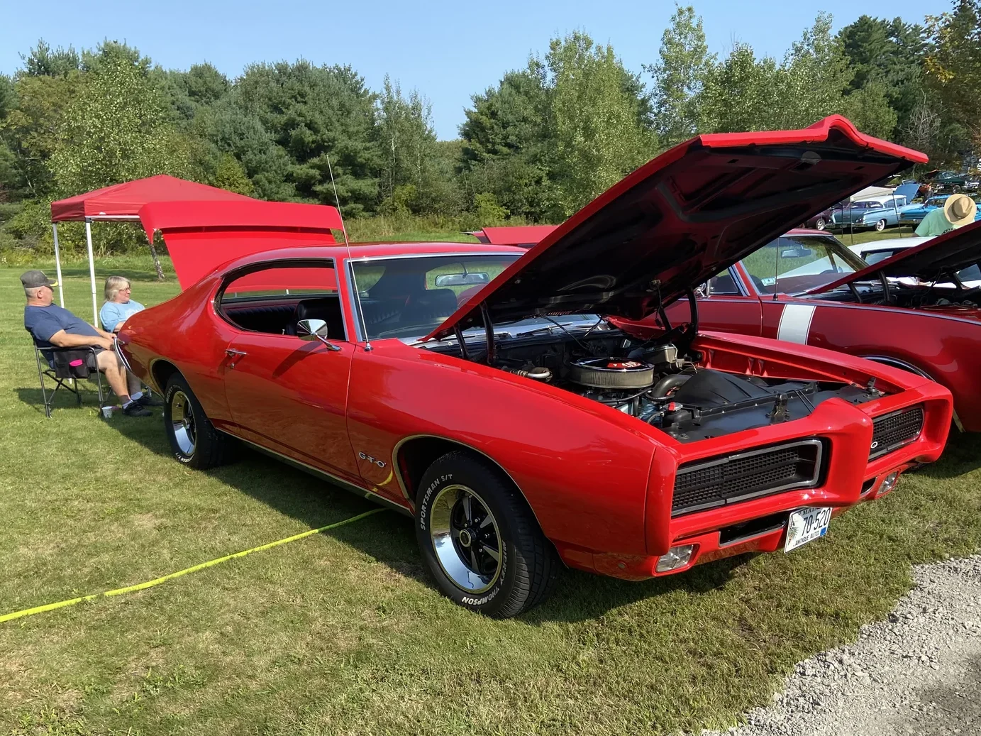 Red 1969 Pontiac GTO with its hood open at Freddie's Cruise-In 2022.