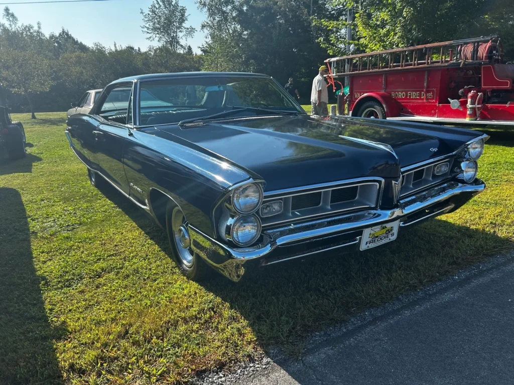 Dark 1965 Pontiac Grand Prix at Freddie's Cruise-In 2023.