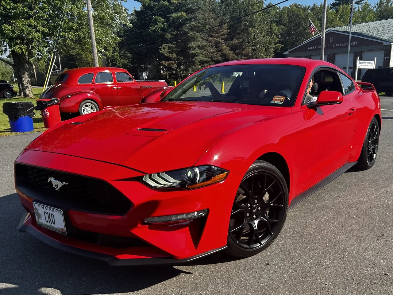 Red Ford Mustang with black wheels at Freddie’s Cruise-In 2023.