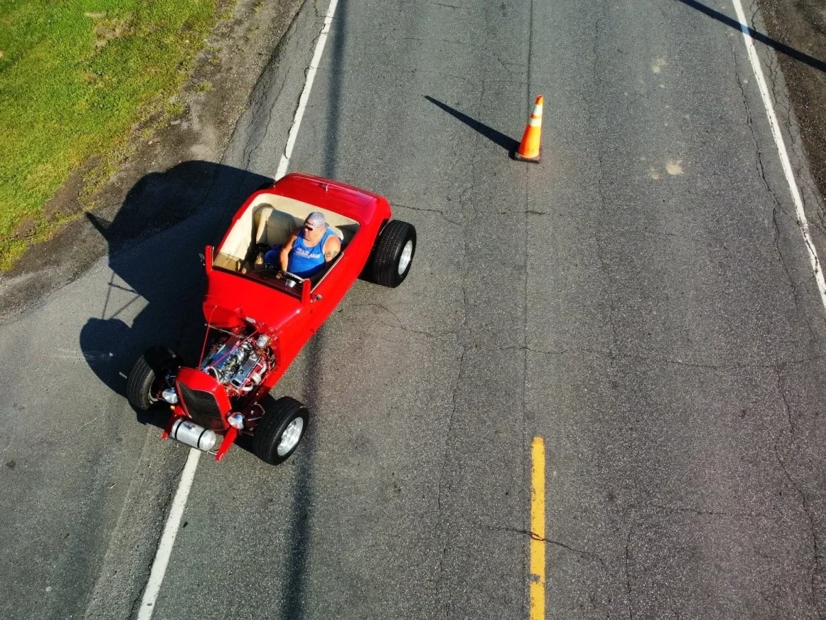 Drone view of a red hot rod at Freddie's Cruise-In 2023.