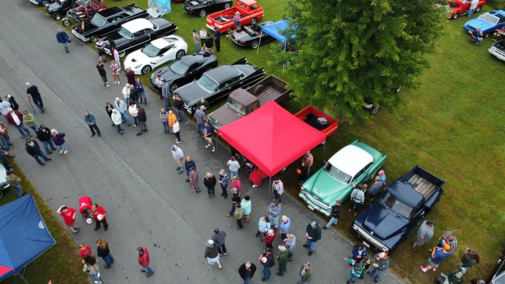Drone view of spectators and show cars at Freddie's Cruise-In 2024.