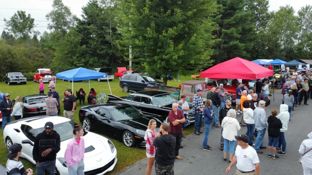 C7 Chevrolet Corvette among cars and spectators at Freddie's Cruise-In 2024.