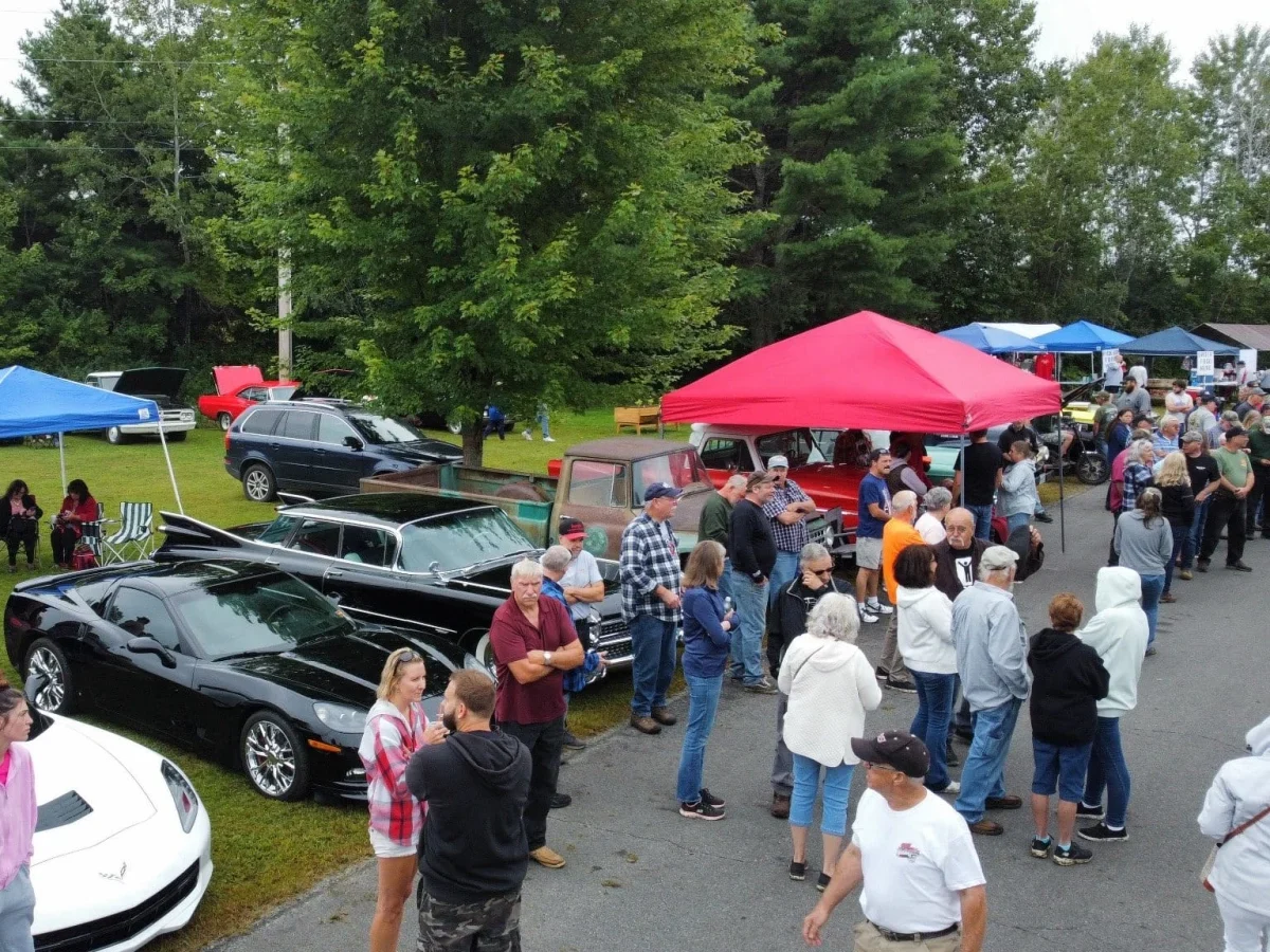 C7 Chevrolet Corvette among cars and spectators at Freddie's Cruise-In 2024.