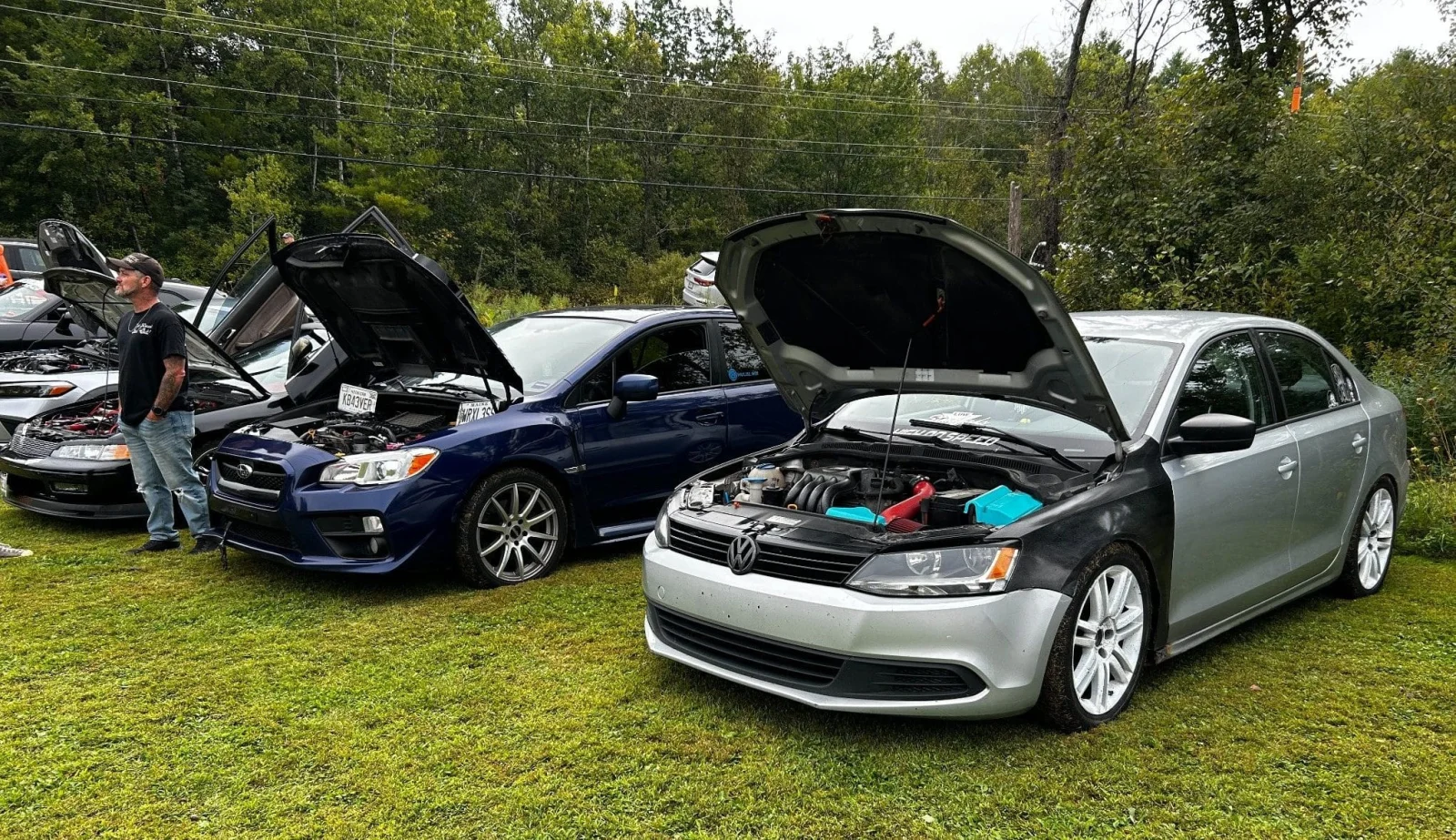 Modern performance cars displayed with their hoods open at Freddie's Cruise-In 2024.