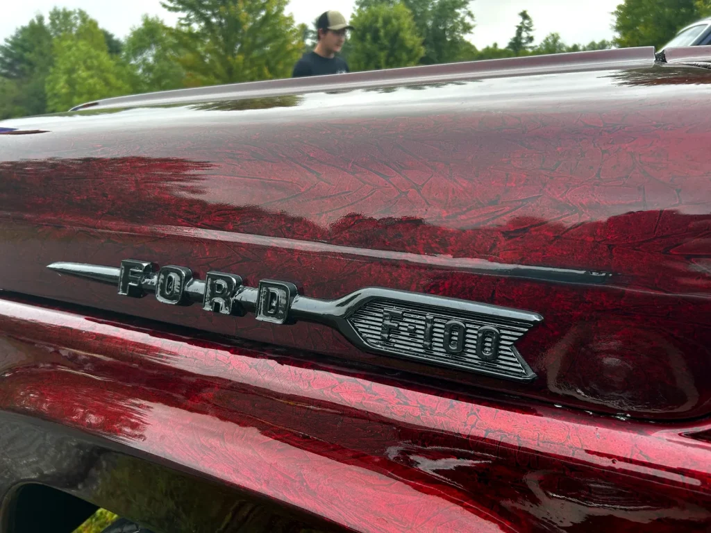 Close-up of a 1960 Ford F-100 hood-side emblem at Freddie's Cruise-In 2025.