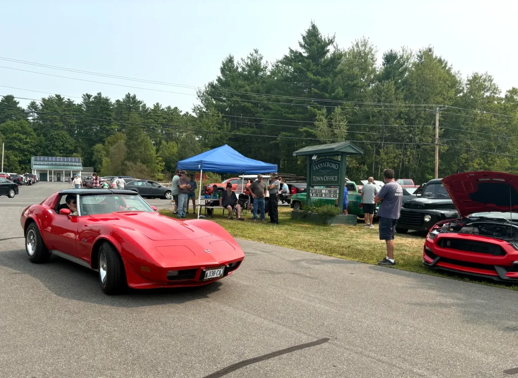 Red 1973–1974 Chevrolet Corvette Stingray driving through Freddie's Cruise-In 2025.