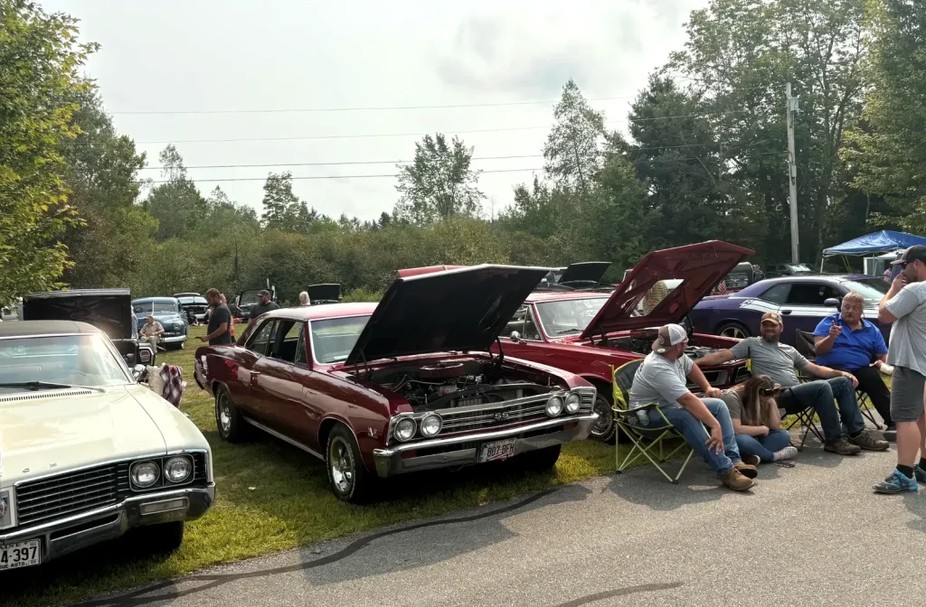 Classic cars, owners, and spectators along the show road at Freddie's Cruise-In 2025.