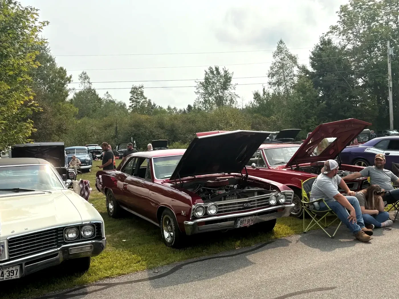 Classic cars, owners, and spectators along the show road at Freddie's Cruise-In 2025.