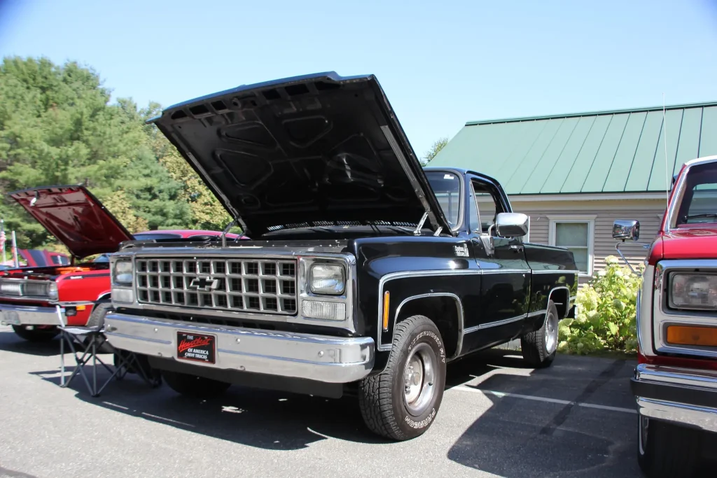 Black Chevrolet square-body pickup with its hood open at Freddie's Cruise-In 2026.