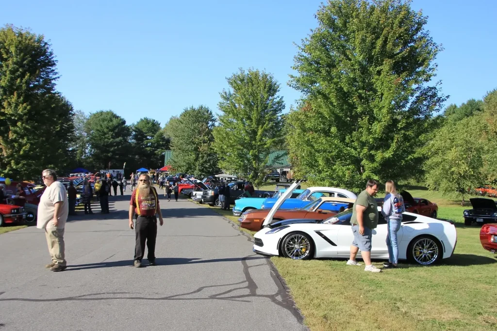 Rows of classic cars and attendees along the main drive at Freddie's Cruise-In 2026 in Vassalboro, Maine.
