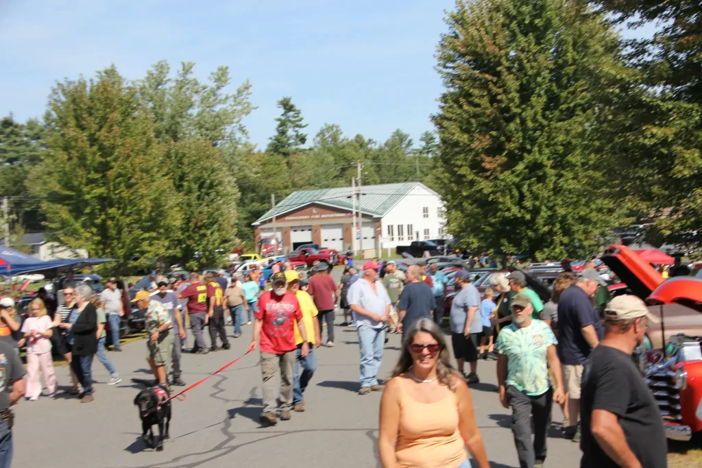 Attendees walking among classic cars at Freddie's Cruise-In 2026 in Vassalboro, Maine.