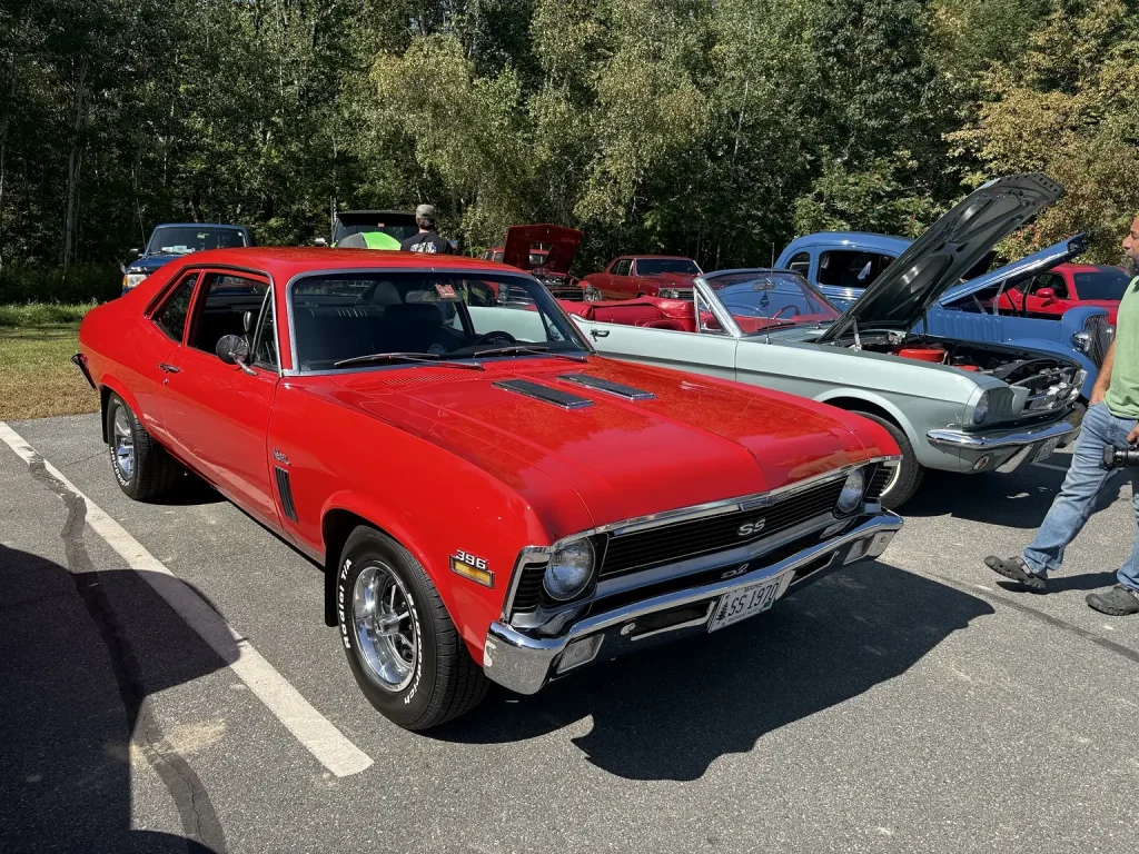 Red Chevrolet Nova displayed in the sun at Freddie's Cruise-In 2026 in Vassalboro, Maine.