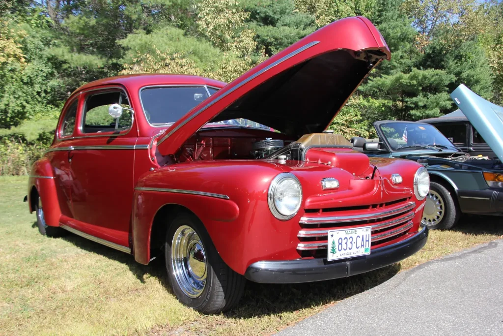 Red vintage Ford with its hood open at Freddie's Cruise-In 2026 in Vassalboro, Maine.