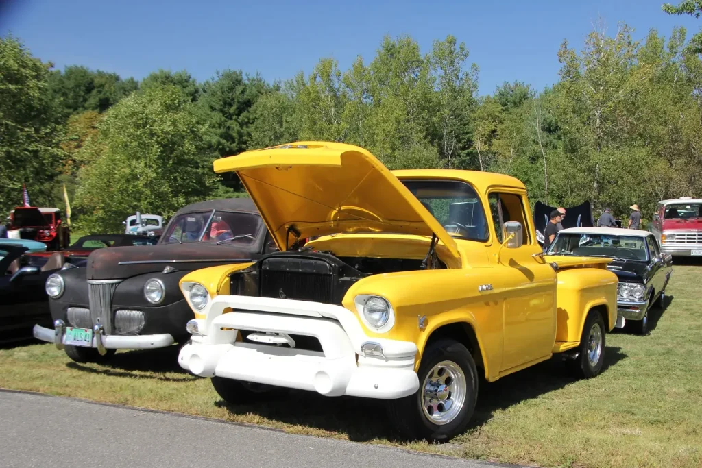 Yellow vintage pickup with its hood open at Freddie's Cruise-In 2026 in Vassalboro, Maine.